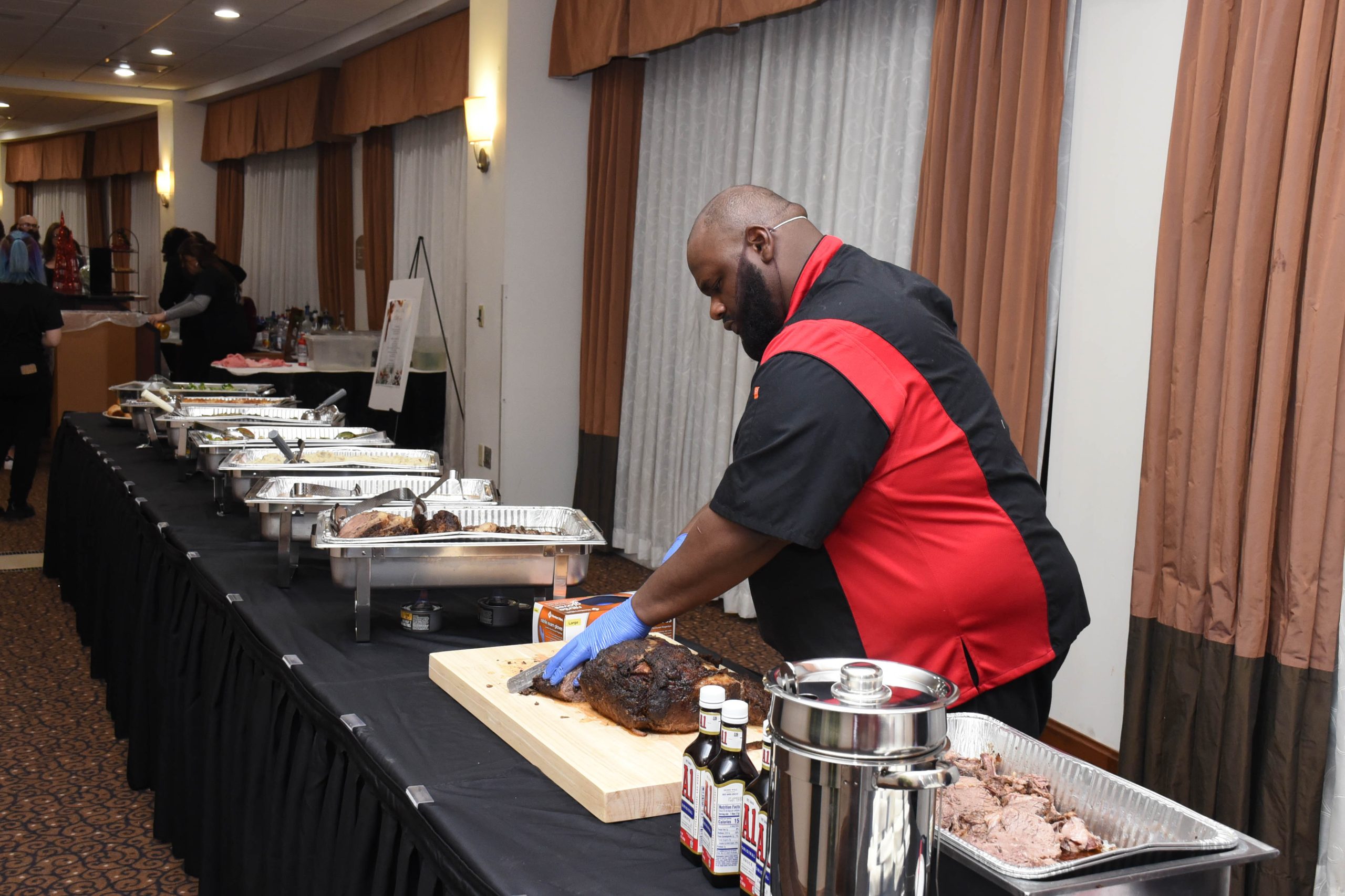 Chef Benny carving brisket at the buffet line